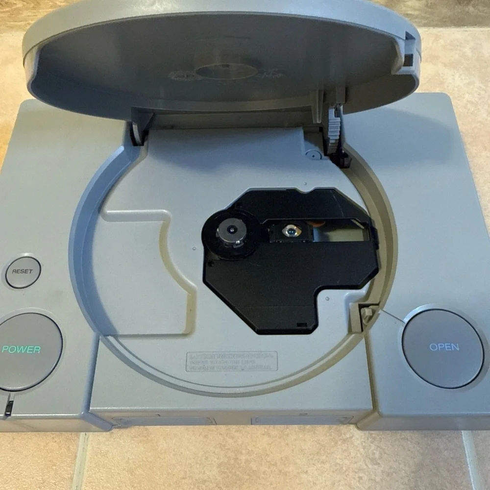 Sony Gray PlayStation Console with Two Wired Gray Controllers